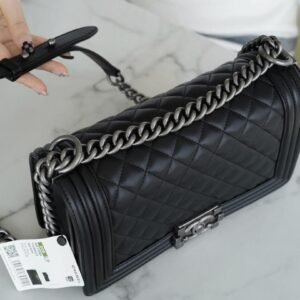 Chanel Boy Flap Bag in lack leather with ruthenium hardware.