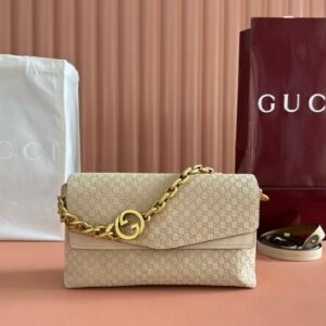 Gucci Large debossed suede shoulder bag with a gold-tone Interlocking G chain