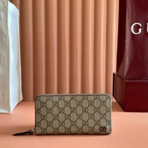 Gucci GG Supreme canvas zip-around wallet with a limited edition charm