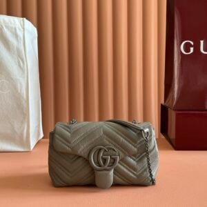 Gucci GG Marmont small shoulder bag featuring matelassé leather with chevron quilting and tonal hardware.