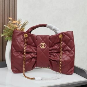 This is a burgundy Chanel 25K Quilted Bow top handle bag